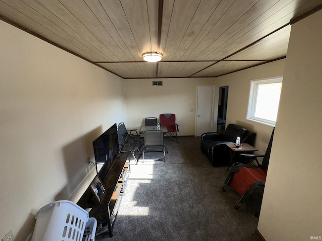 interior space with carpet flooring and wood ceiling