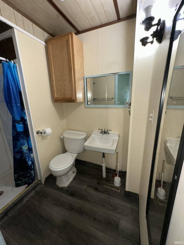 bathroom with wood-type flooring, curtained shower, wooden ceiling, and sink