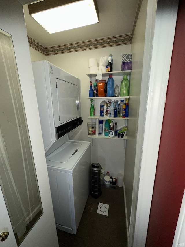 washroom featuring stacked washing maching and dryer