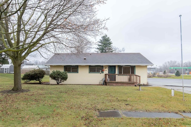 ranch-style house with a front yard and a deck