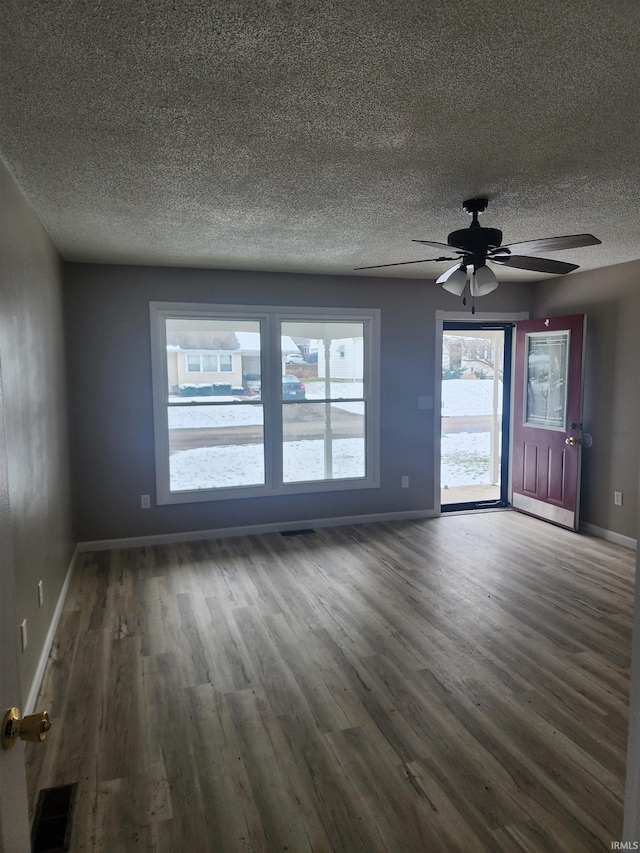 spare room with ceiling fan and dark wood-type flooring