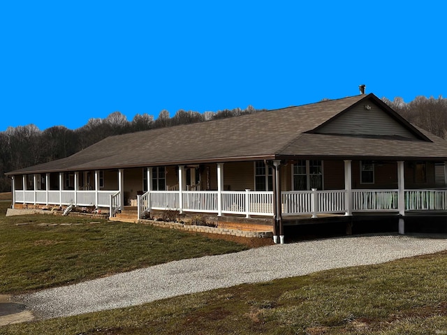 farmhouse featuring a front yard and a porch