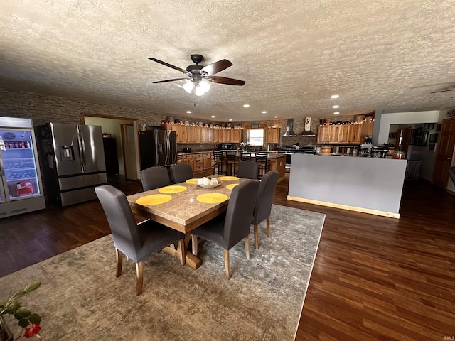 dining room featuring ceiling fan, dark wood-type flooring, and a textured ceiling