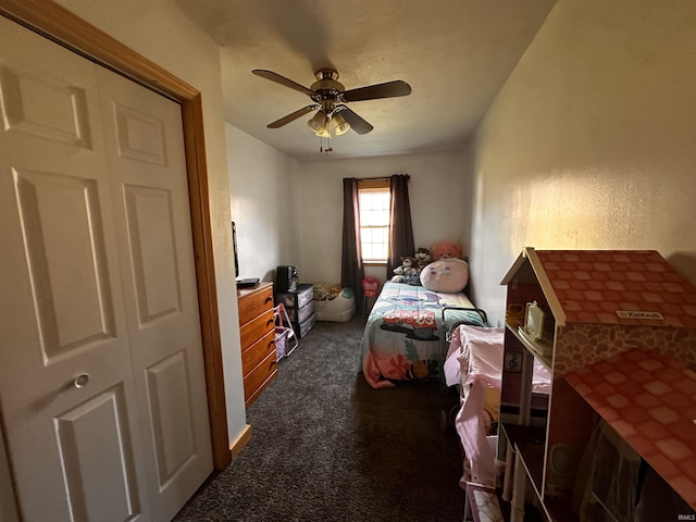 carpeted bedroom with ceiling fan and a closet