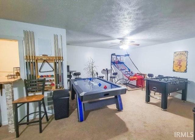 game room featuring ceiling fan, carpet, and a textured ceiling