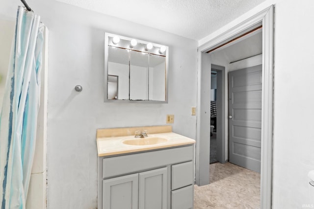 bathroom with vanity and a textured ceiling