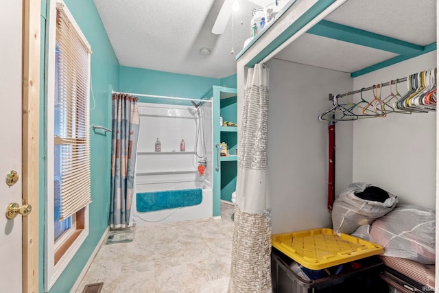 bathroom with a textured ceiling and walk in shower