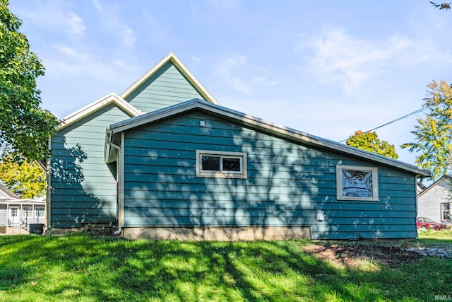 view of side of home with a lawn