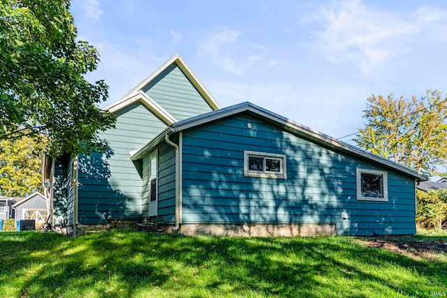 exterior space with a lawn and central air condition unit