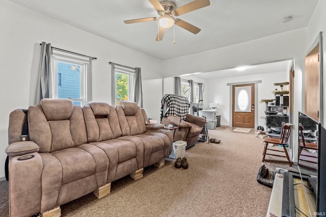 carpeted living room with ceiling fan