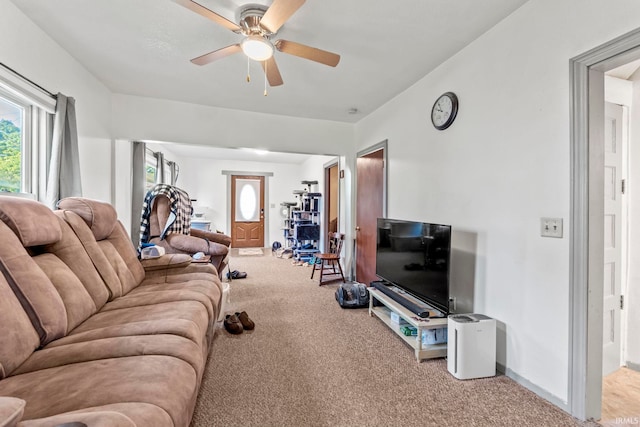 carpeted living room with ceiling fan