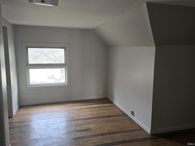 bonus room featuring dark hardwood / wood-style floors and lofted ceiling