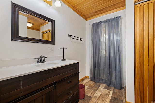 bathroom featuring vanity, wooden ceiling, vaulted ceiling, and hardwood / wood-style flooring