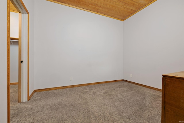 unfurnished room featuring carpet and wood ceiling