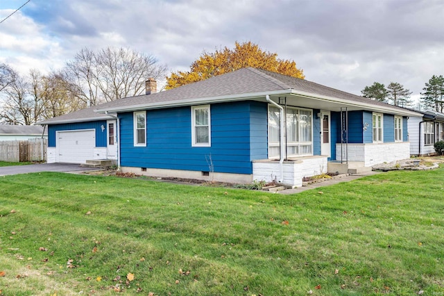 ranch-style house with a garage and a front lawn