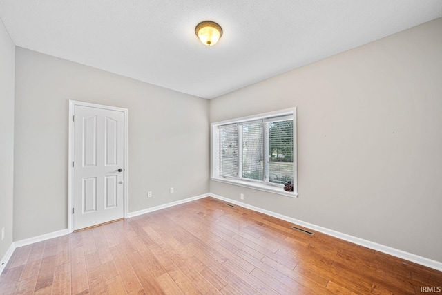 spare room with hardwood / wood-style floors