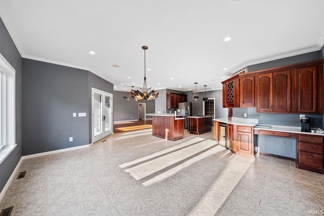 kitchen featuring french doors, crown molding, decorative light fixtures, stainless steel fridge with ice dispenser, and a kitchen island