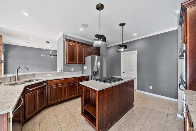 kitchen with dark brown cabinetry, sink, a kitchen island, and appliances with stainless steel finishes