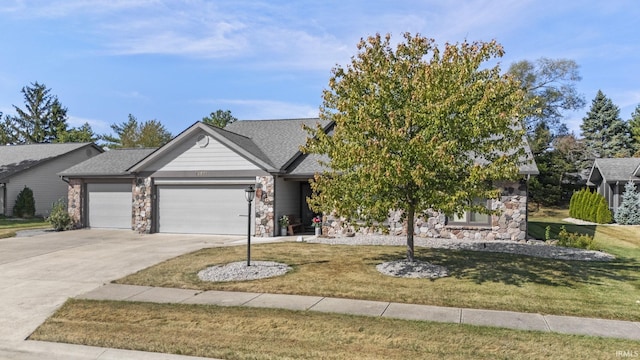 view of front of house featuring a garage and a front lawn