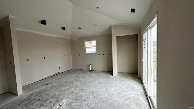 empty room featuring lofted ceiling