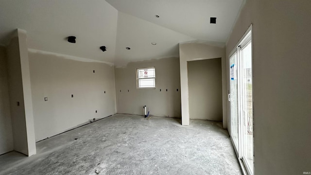 unfurnished room featuring lofted ceiling