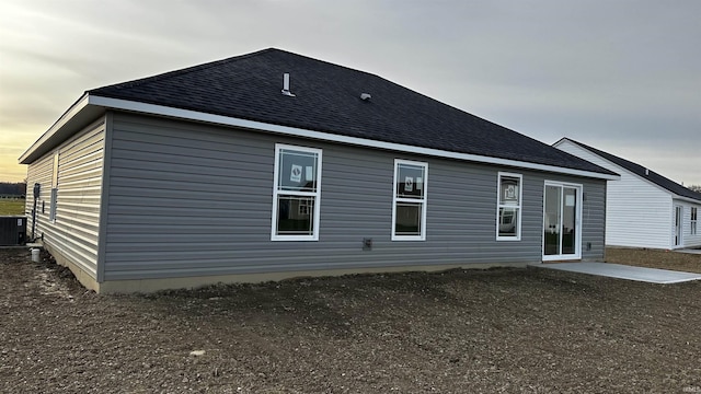 rear view of house with a patio area and central AC unit