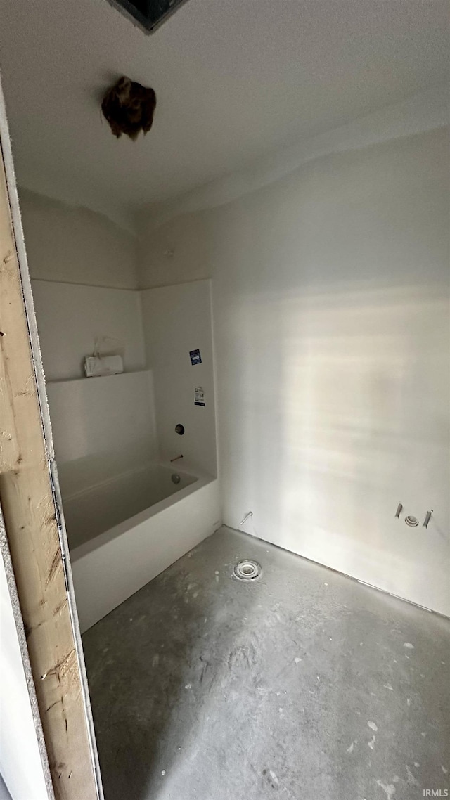 bathroom featuring concrete floors and a bathing tub