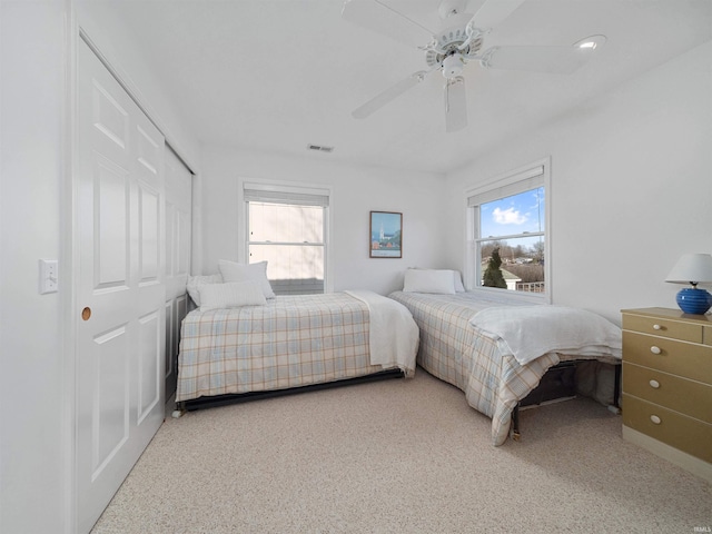 bedroom featuring ceiling fan and multiple windows