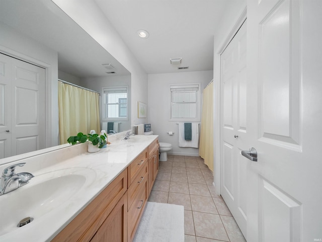 bathroom featuring tile patterned flooring, vanity, and toilet