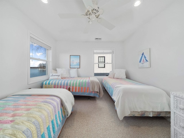 carpeted bedroom with ceiling fan