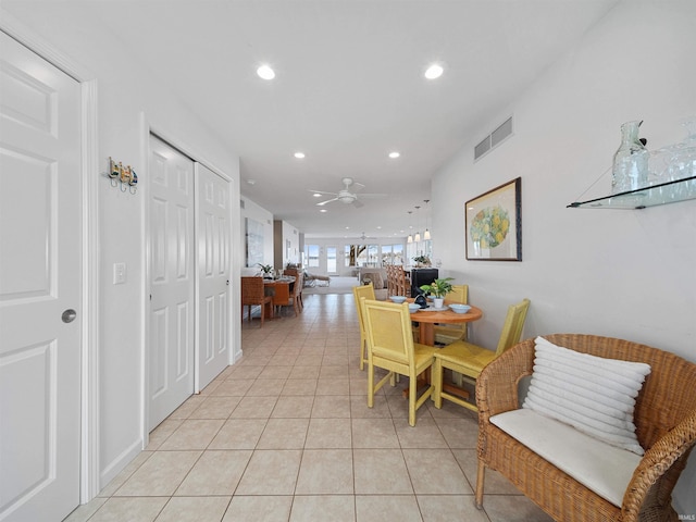 dining space featuring ceiling fan and light tile patterned floors