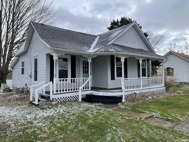 view of front facade with cooling unit and a porch