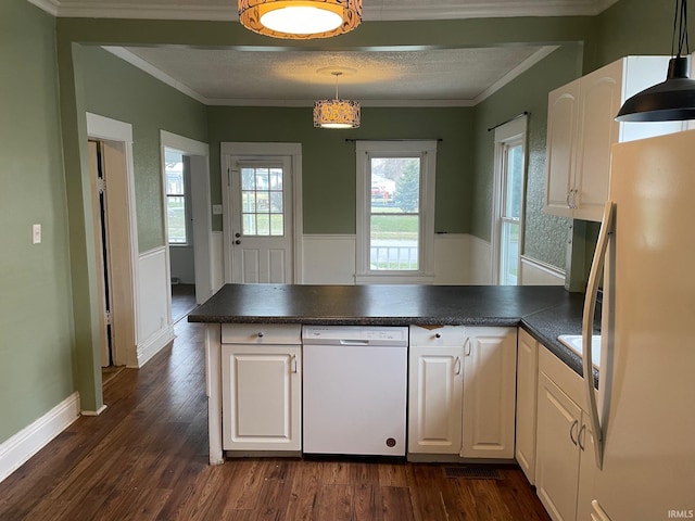 kitchen featuring kitchen peninsula, white appliances, crown molding, pendant lighting, and white cabinetry