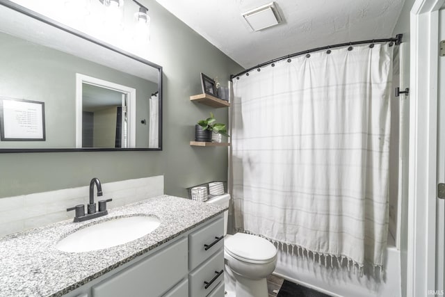 full bathroom with shower / bath combo, vanity, and toilet