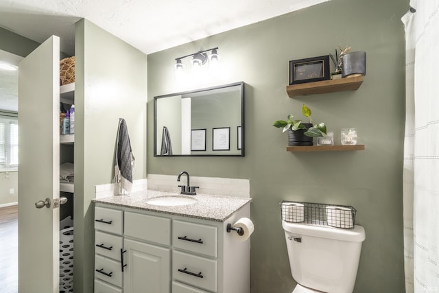 bathroom with vanity and toilet