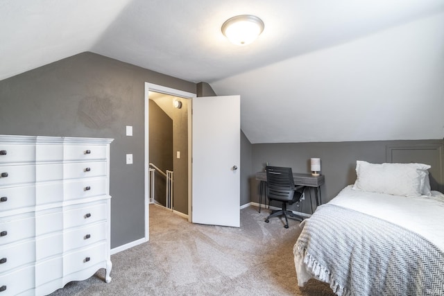 bedroom featuring light colored carpet and lofted ceiling