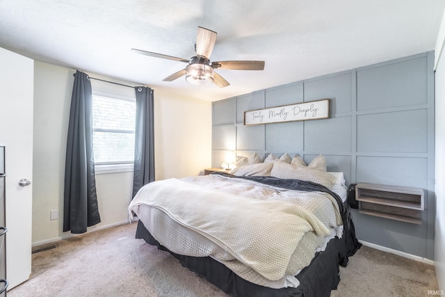 bedroom with light carpet and ceiling fan