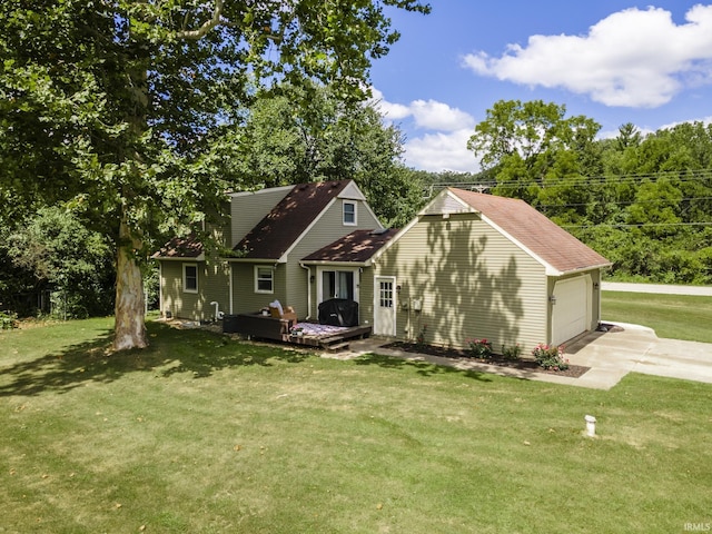 cape cod home with a garage, a front lawn, and an outdoor structure