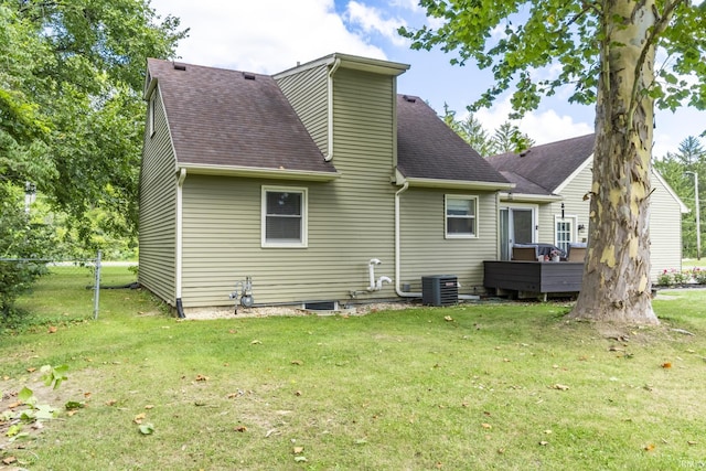 rear view of property with a yard and cooling unit