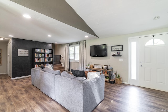 living room with dark hardwood / wood-style floors and vaulted ceiling