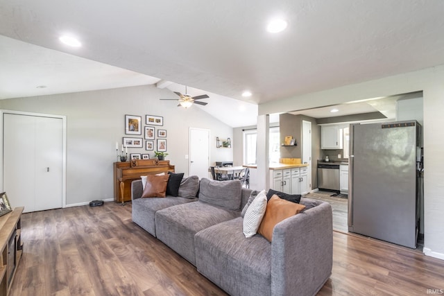 living room featuring vaulted ceiling with beams, ceiling fan, and hardwood / wood-style floors