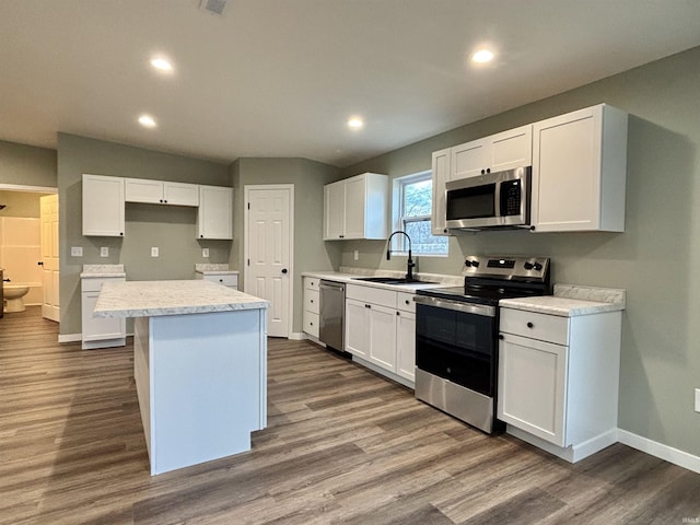 kitchen featuring white cabinetry, sink, a kitchen island, and stainless steel appliances