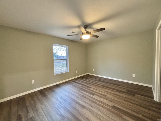 spare room featuring dark hardwood / wood-style floors and ceiling fan