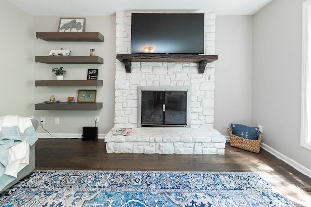 unfurnished living room featuring wood-type flooring and a fireplace