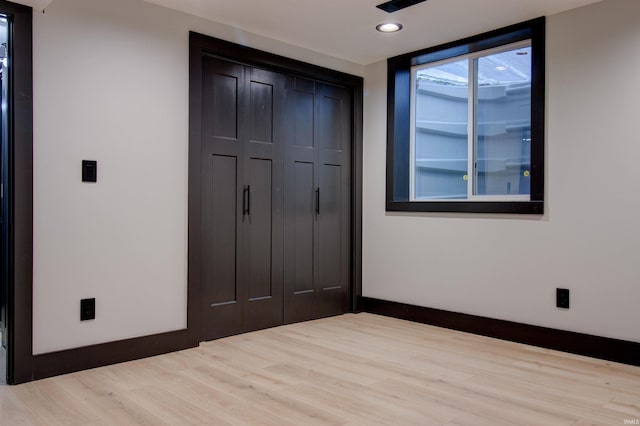 interior space featuring hardwood / wood-style floors, expansive windows, and a closet