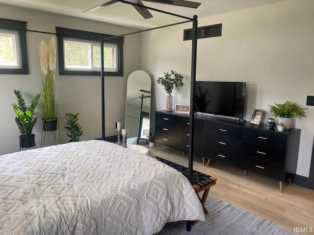 bedroom with ceiling fan and light wood-type flooring