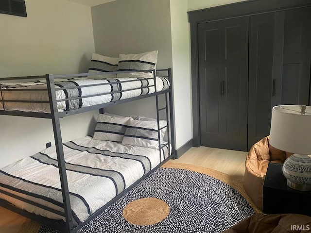 bedroom featuring light hardwood / wood-style flooring and a closet