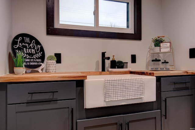 bar featuring gray cabinets and wooden counters