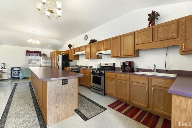 kitchen featuring stainless steel appliances, sink, decorative light fixtures, a notable chandelier, and a kitchen island