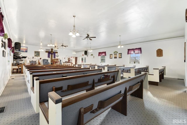 misc room with light carpet and ceiling fan